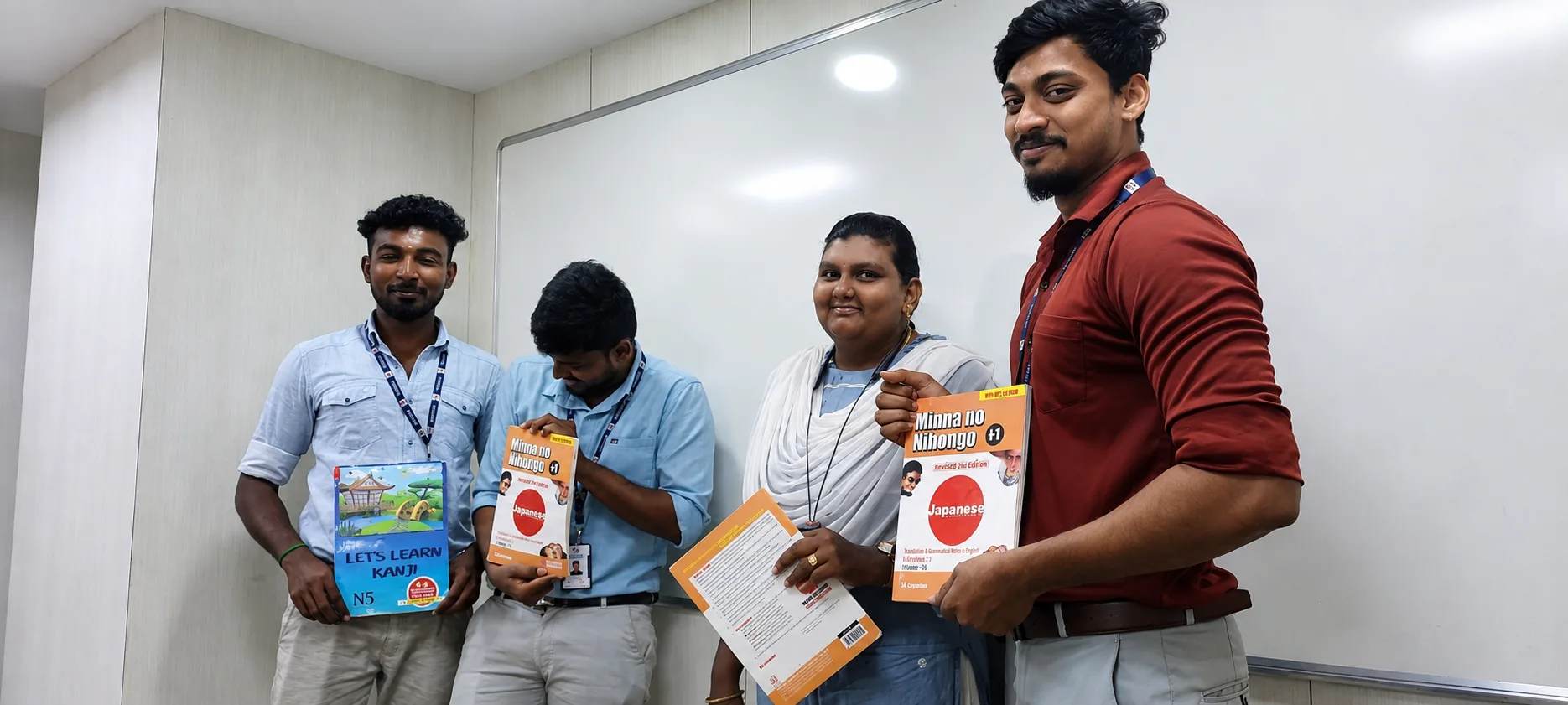 A group photo showing course materials during Japanese language training